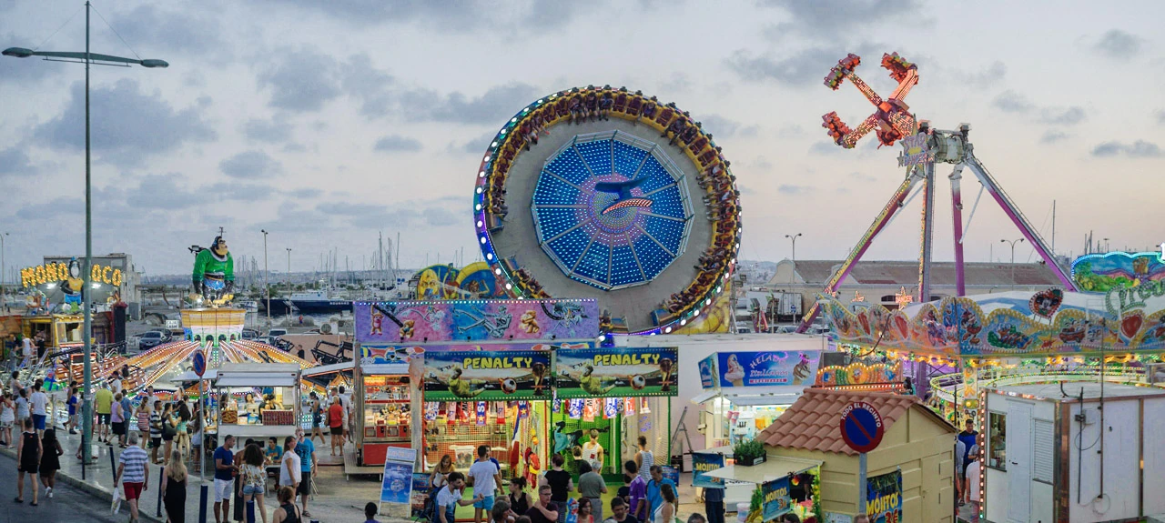 Colourful rides at a funfair.